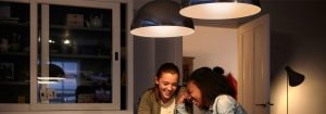 „Nowoczesne lampy wiszące LED tworzą ciepłą atmosferę dla dwóch kobiet, prezentując energooszczędne rozwiązania oświetlenia domowego”.